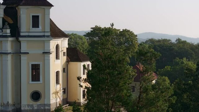 Aerial view of the beautiful Kostel sv. Jana Krtitele a Panny Marie Karmelske church surrounded by trees and scenic countryside, Smolotely, Czech Republic.