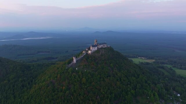 Aerial view of bezdez castle at sunset surrounded by serene forest and lush greenery, bezdez, czech republic.