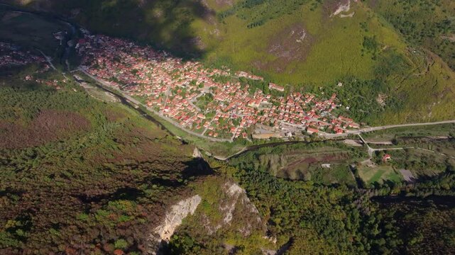Aerial view of picturesque village along the Vit River with beautiful homes and buildings, Glozhene, Bulgaria.