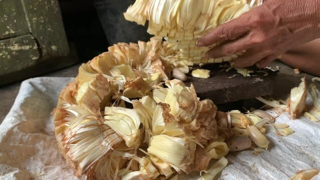 chop the young jackfruit into small pieces. manual process. preparation for cooking jackfruit.