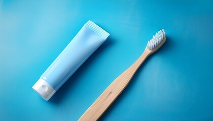 A toothbrush and toothpaste tube on a soft pastel blue background, leaving room for a headline.