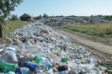 Landfill overflowing with plastic bottles and waste in rural area