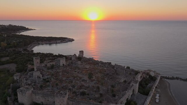 Aerial view of antik kiz kalesi at sunrise over the tranquil mediterranean sea, Kizkalesi, Turkey.