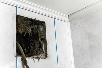 Dust, dirt, debris, and cobwebs accumulating in a ventilation grille indicate poor air quality and...