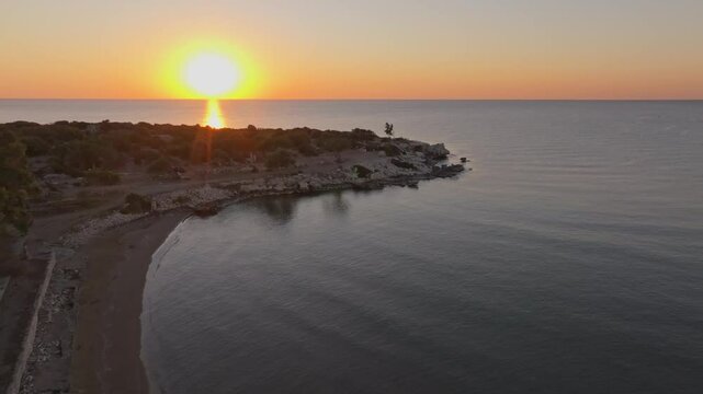 Aerial view of Antik Kiz Kalesi at sunrise over the tranquil Mediterranean Sea, Kizkalesi, Turkey.