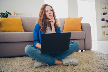 Photo of dreamy cute girl wear blue shirt sit floor shopping from home weekend living room...