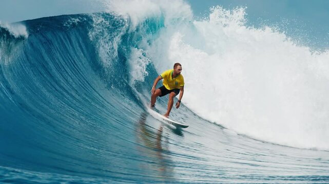 Wave surfing. Man surfs the wave in the Maldives