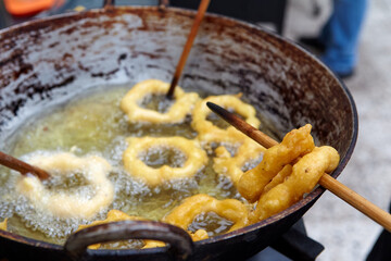 Peruvian picarones are a traditional dessert commonly found in Peru. They are a type of doughnut made from a sweet potato and pumpkin batter, which is deep-fried until golden brown.