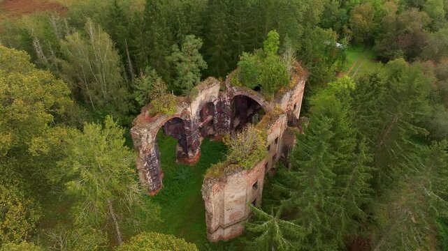 Aerial view of the historic ruins of St. Jana Krtitele church surrounded by tranquil greenery and ancient trees, Kocov, Czech Republic.