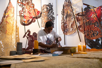 Craftsmen create traditional Thai Khon puppets.
