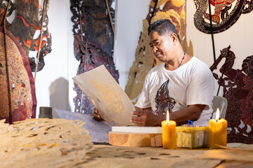 Craftsmen create traditional Thai Khon puppets.