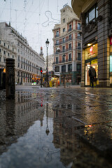 Fototapeta premium Water reflections in an empty street in the city