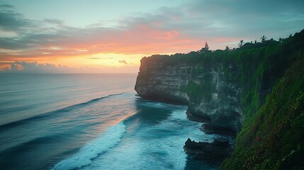 Dramatic sunset over ocean cliff, lush vegetation, waves crashing.