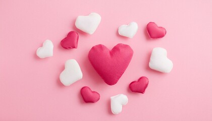 Fototapeta premium Pink Love Heart Arrangement: A cluster of pink and white hearts arranged in a soft and romantic design on a delicate pink background. This image evokes warmth, affection, and pure love.