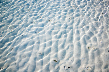 white sand texture in clear sea water