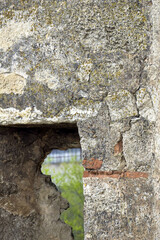 Prat of window opening in an old ruined building. Ancient masonry. Close-up. Copy sace. Selective focus.