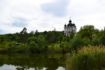 Picturesque view of Orthodox Cathedral with black domes in monastery against cloudy sky. Kurki Monastery in Moldova was founded in 1773. Concept religion, christianity, orthodoxy.