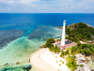 Belitung beach and islands drone view with Lengkuas Island lighthouse. Beautiful aerial view of islands, boat, sea and rocks in Belitung, Indonesia 