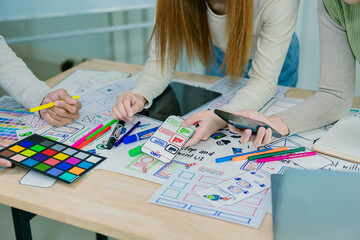 Fototapeta premium Application development UI UX web designer team is working together to develop a mobile responsive website with UI UX front end designer examples,