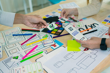 Application development UI UX web designer team is working together to develop a mobile responsive...
