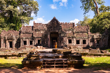 Fototapeta premium Tourist entering Angkor ancient temple ruins in Cambodia