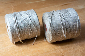spools of twine rope on a wooden table