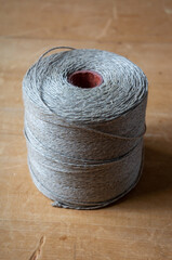 spool of twine rope on wooden table