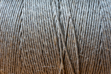 spool of twine rope on wooden table, close up