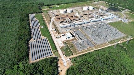 LNG or natural gas power plant next to solar farm in a very clean environment seen from drone
