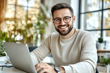 Smiling Caucasian Man Working on Laptop in Modern Workspace