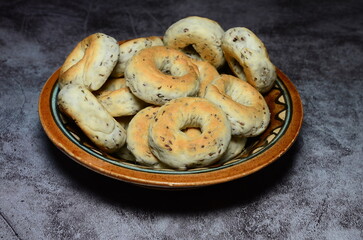 A closeup shot of Anise cookies stacked over each others with a beautiful service dish in the...