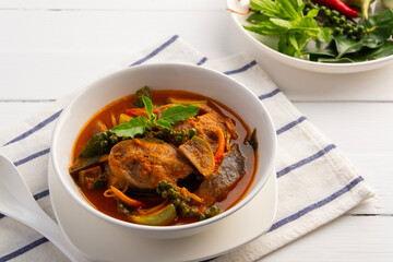 Spicy Catfish clear curry.Thai Jungle Curry with catfish and eggplant with fingerroot (Gaeng Pa),Thai hot and spicy curry soup without Coconut Milk in white bowl.
