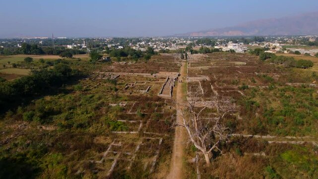 Aerial view of ancient ruins and archeological site of Dharmarajika Stupa in the beautiful landscape of Taxila, Punjab, Pakistan.