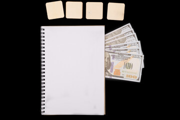 Financial Planning Toolkit: Notebook, Prop Money, and Blank Tiles on Black