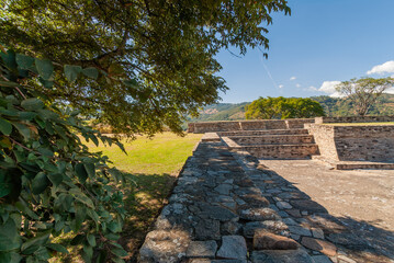 Architectural remains in Mixco Viejo, an ancient Mayan city, testimony of a great civilization, in the middle of green forests, ravines, under a blue sky.