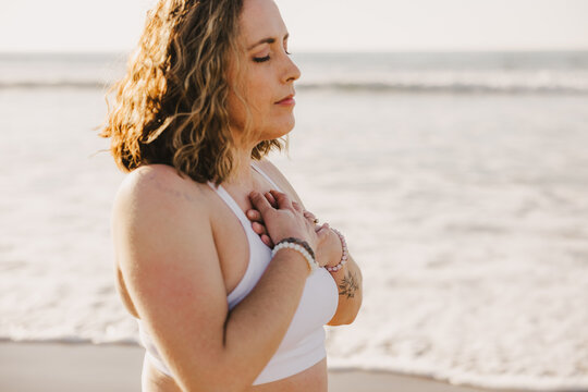 Yoga Teacher With Hands Over Heart
