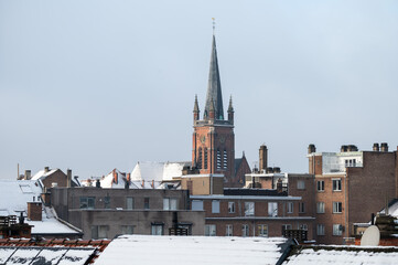 Panoramic view in snow of a residential area with church tower in Jette, Brussels Capital Region, JAN 9, 2025