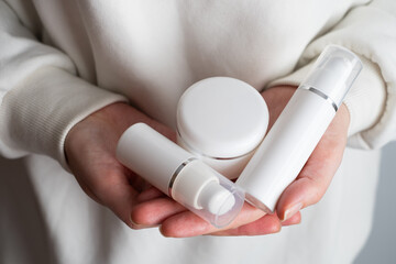 A jar of spa cream in the hands of a girl. Skin care. Medical and dermatological cosmetics for hands. Beauty and health of a woman. Spa treatments for the body. Container with natural cream close-up