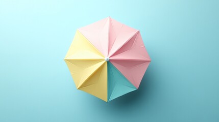 Pastel pink, yellow, and blue umbrella overhead view on light blue background.