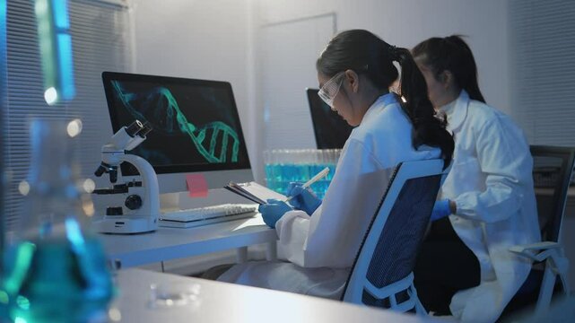 Female scientist analyzing intricate dna structure on advanced computer screen, showcasing cutting edge genetic research in modern laboratory workspace