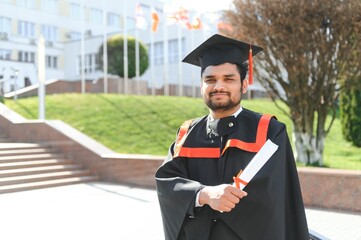 education, graduation and people concept - happy Indian Male graduate student