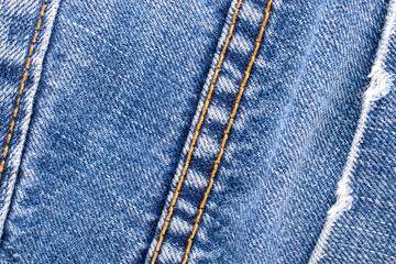 Naklejka premium Separate fragments of good old jeans, macro, top view.