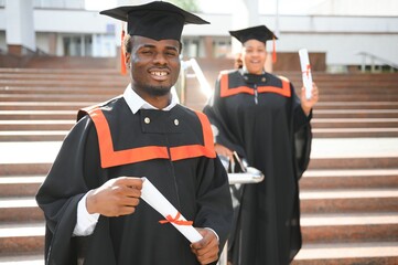 Happy graduate. Happy African man in graduation gowns