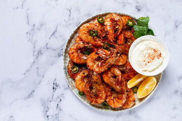Grilled shrimps served with hot sauce and slices of fresh lemon, homemade, no people,
