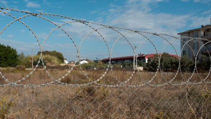 a plot of land fenced off with a barbed wire