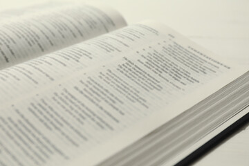 Obraz premium Open Holy Bible in English language on table, closeup