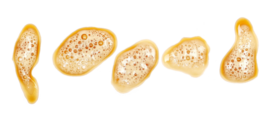 Spilled dark stout beer puddle with foam, isolated on white, top view, clipping path
