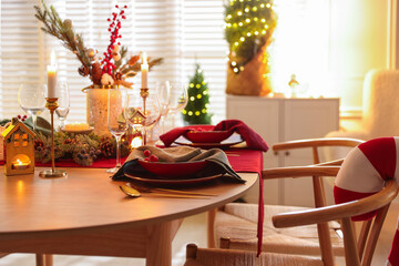 Christmas table setting with stylish dishware and festive decor indoors
