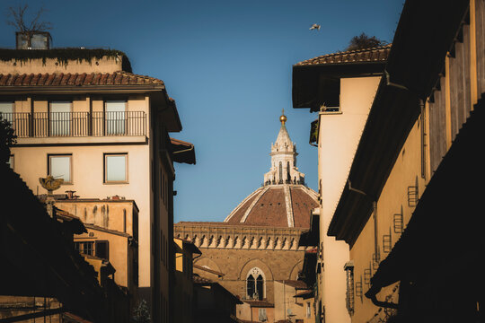 View of cathedral of santa maria del fiore and piazza del duomo with picturesque rooftops, tuscany, italy.