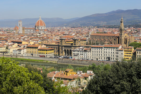 View of cathedral of santa maria del fiore and arno river with vibrant orange rooftops, florence, italy.